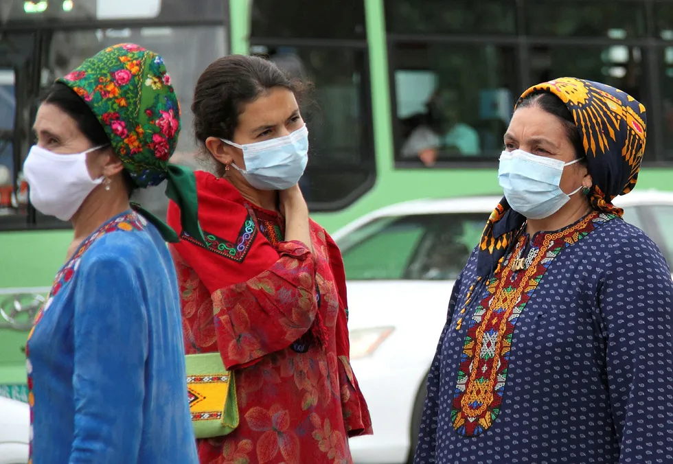 Coronavirus: women wearing protective face masks are seen at a bus stop in Ashgabat, Turkmenistan