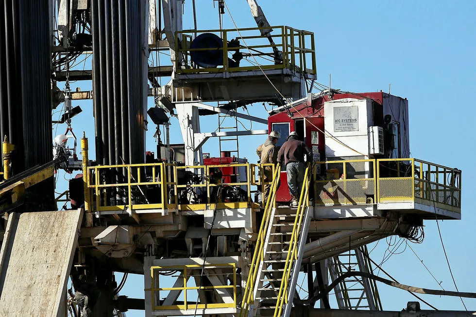 In play: workers stand on the platform of a fracking rig in the Permian basin