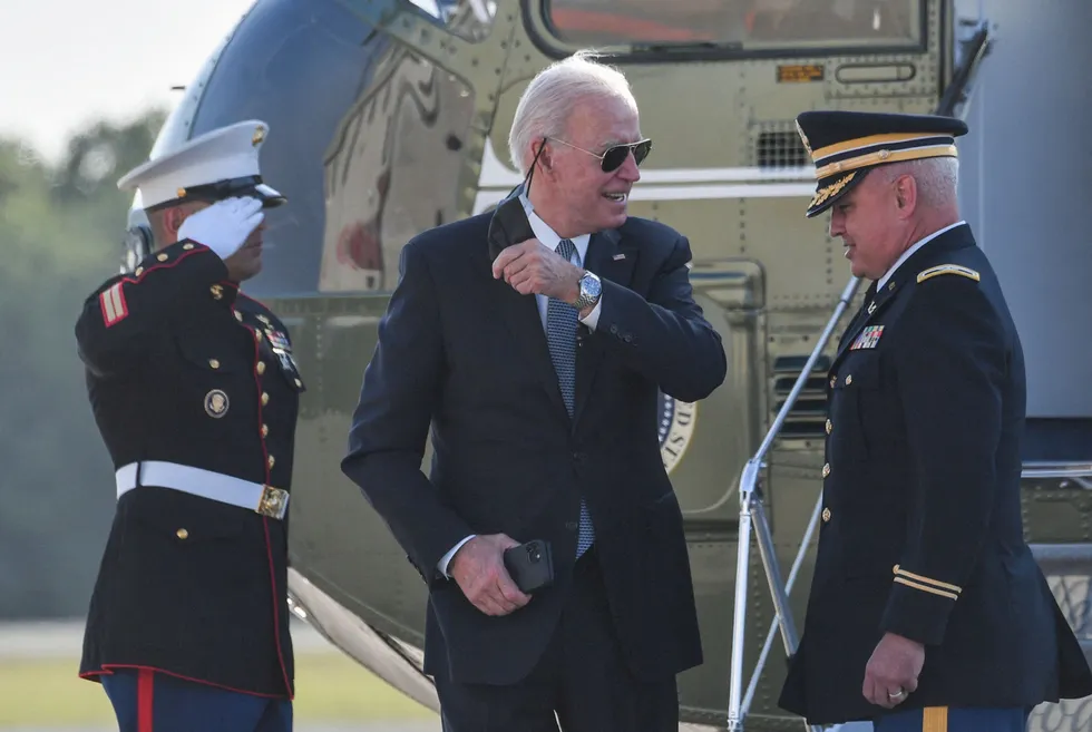 Uncovered: Joe Biden takes off his mask as he arrives at the National Guard air base in Wilmington, Delaware, on Tuesday