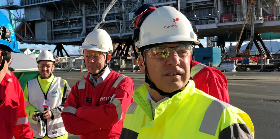 Equinor CEO Anders Opedal (right) in front of Johan Sverdrup oil field living quarters topsides