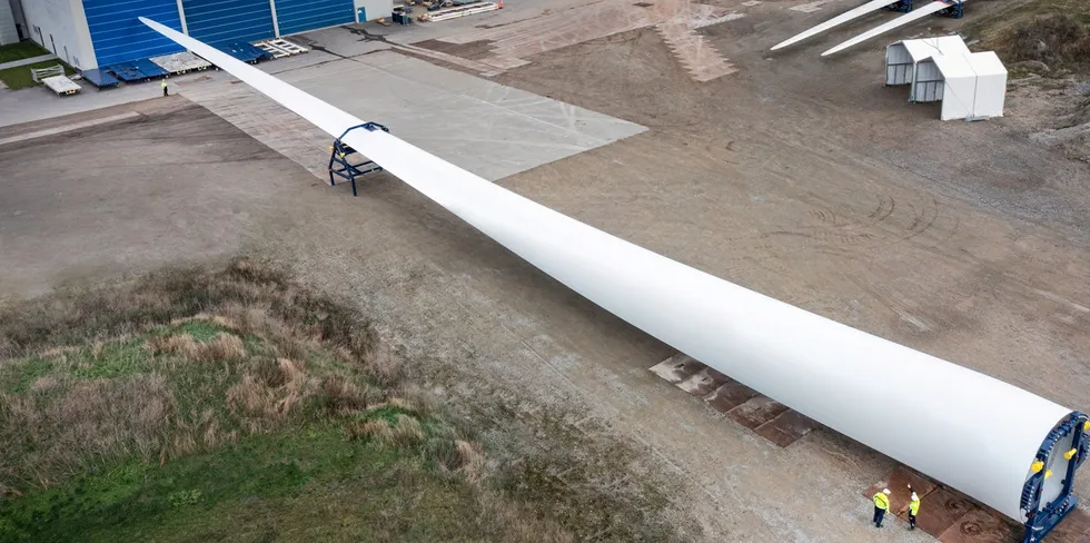Vestas employees perform final checks on the first 15 megawatt V236 wind turbine blade at their factory in Nakskov.