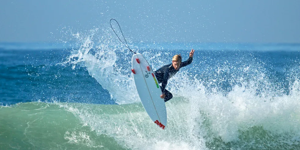 Huntington Beach, CA / USA - October 6, 2017: Surfer Clay Pfaendler surfing off the coast of Huntington Beach California on a DMA Surfboard . California surfer.