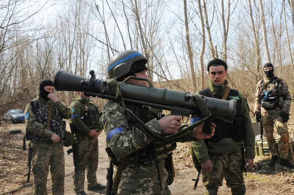 Breaking the bond: Ukrainian servicemen study a Swedish shoulder-launched weapon system during a training session near Kharkiv, Ukraine in April 2022