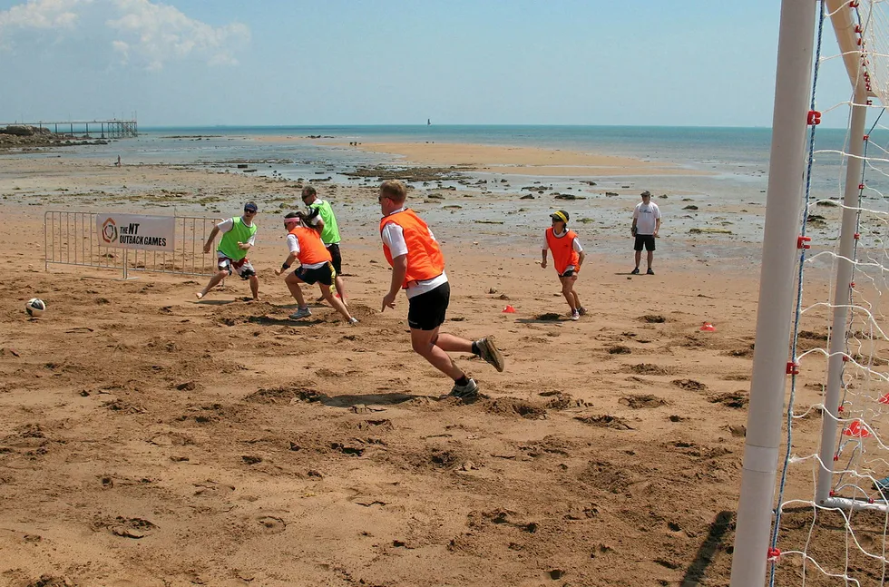 Closing in on goal: players in a game of sandbar soccer in Darwin, Australia