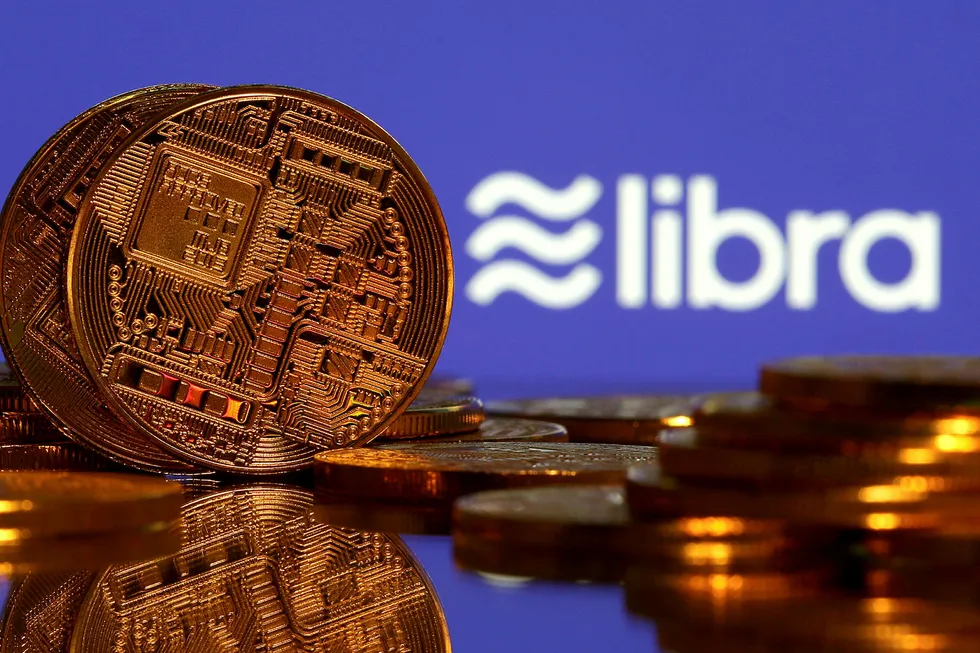 FILE PHOTO: Representations of virtual currency are displayed in front of the Libra logo in this illustration picture, June 21, 2019. REUTERS/Dado Ruvic/Illustration/File Photo