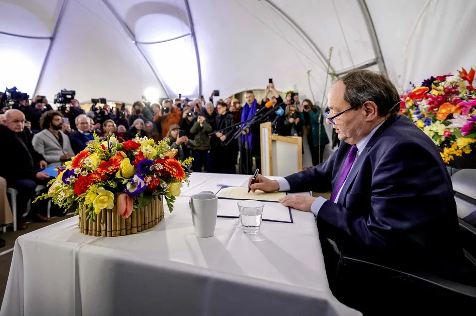 Outgoing Dutch State Secretary for the Extractive Industries Hans Vijlbrief symbolically signs the law on closing the Groningen gas field in Kolham, in April.