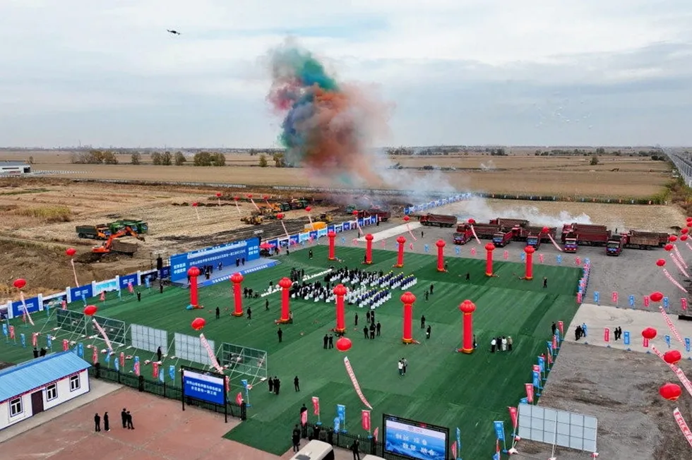 Celebratory coloured smoke hangs in the air at the project's groundbreaking ceremony in the Shuangyashang Economic and Technological Development Zone, Heilongjiang province, on Tuesday.