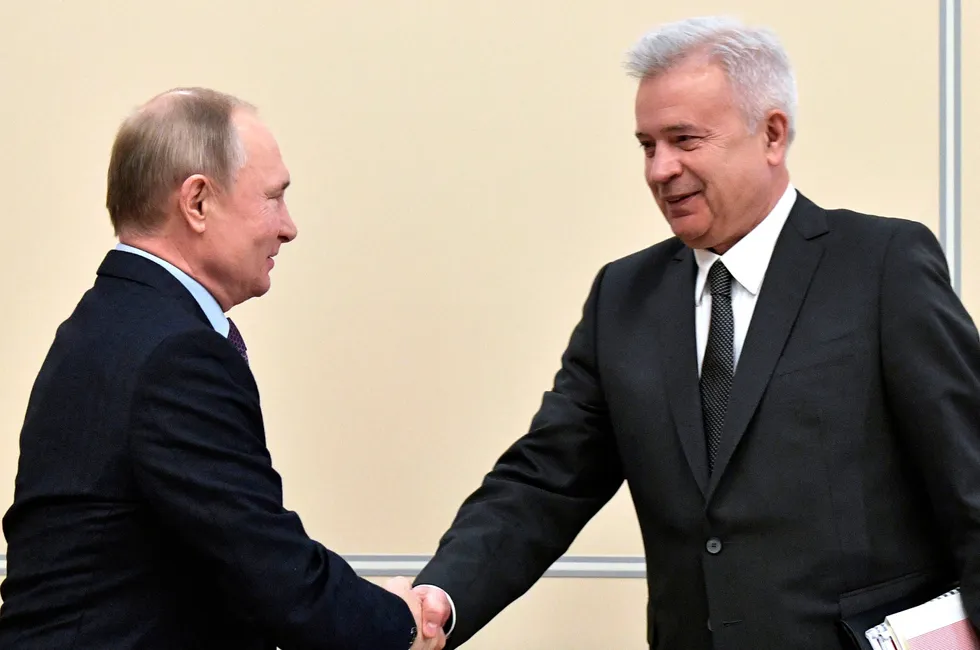 Russian President Vladimir Putin (left) shakes hands with Lukoil founder and former president Vagit Alekperov, who chairs the Our Future foundation in Moscow.