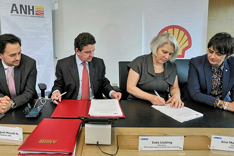Offshore: Colombian regulators Diego Mesa and Luis Miguel Morelli (left) sign paperwork with Shell's Colombia team Ines Liebing and Ana Maria Duque for two offshore blocks