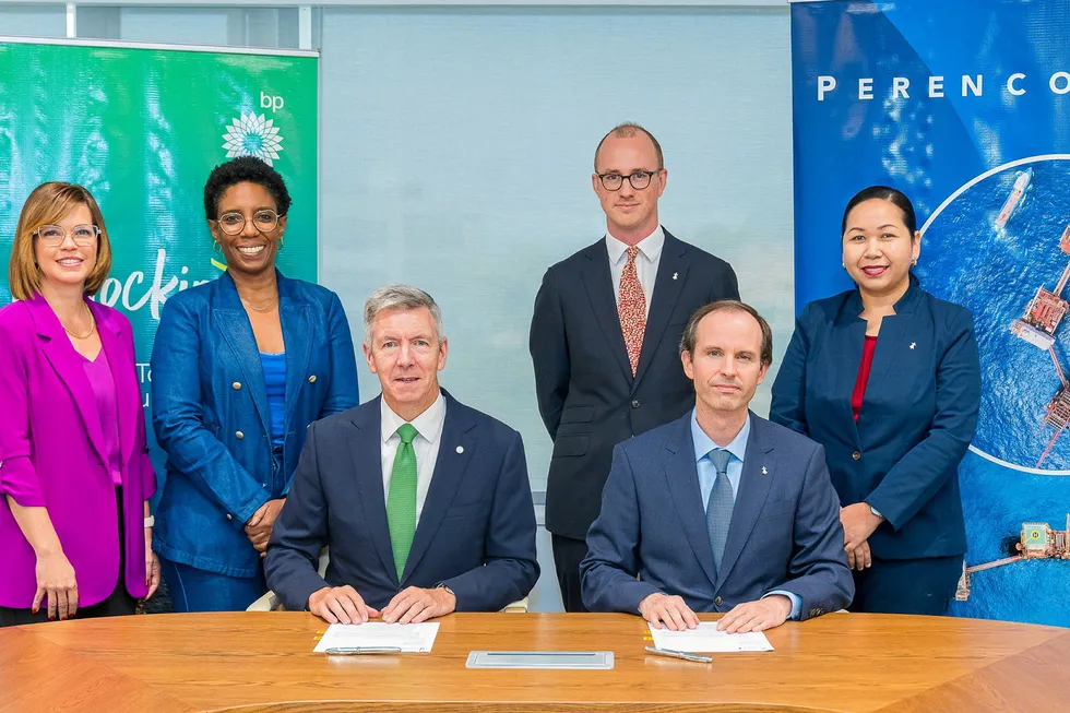 David Campbell, president of BP Trinidad & Tobago (front left) and Gregoire de Courcelles, general manager at Perenco T&T sign asset sales deal.