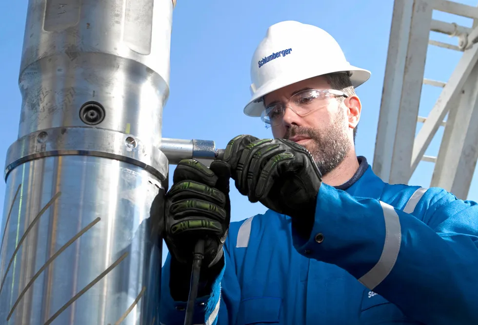 New contracts: a Schlumberger field engineer prepares equipment for downhole deployment