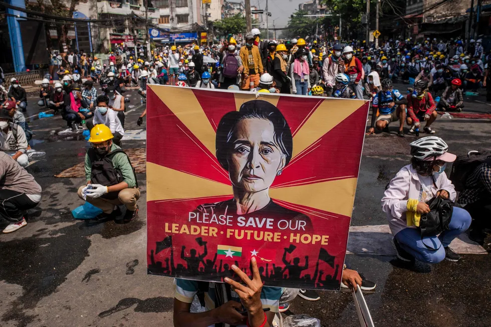 Convicted: a protester holds a poster featuring detained civilian leader Aung San Suu Kyi during a March 2021 demonstration against the military coup in Yangon, Myanmar