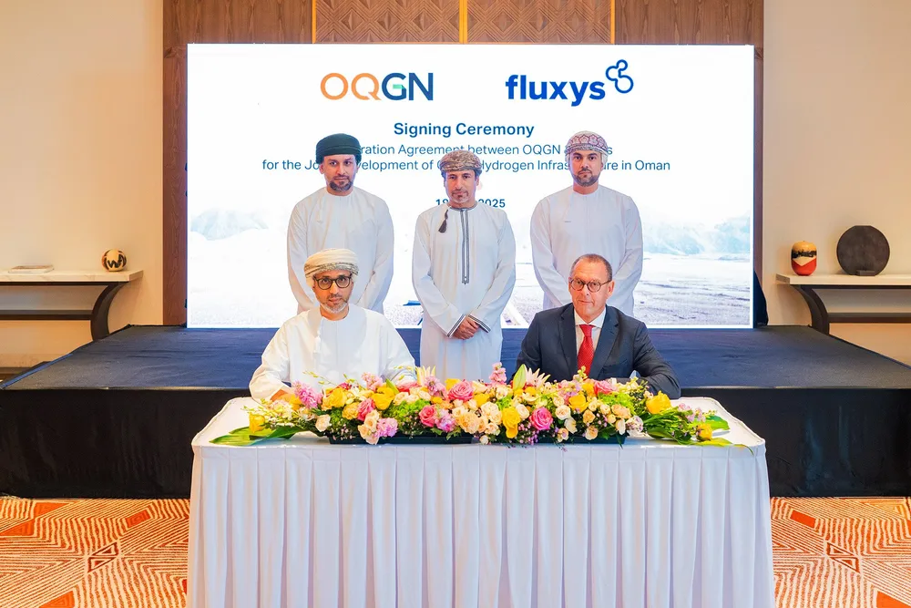 A signing ceremony between OQGN and Fluxys, attended by Oman's energy minister Salim Al Aufi (standing, centre)
