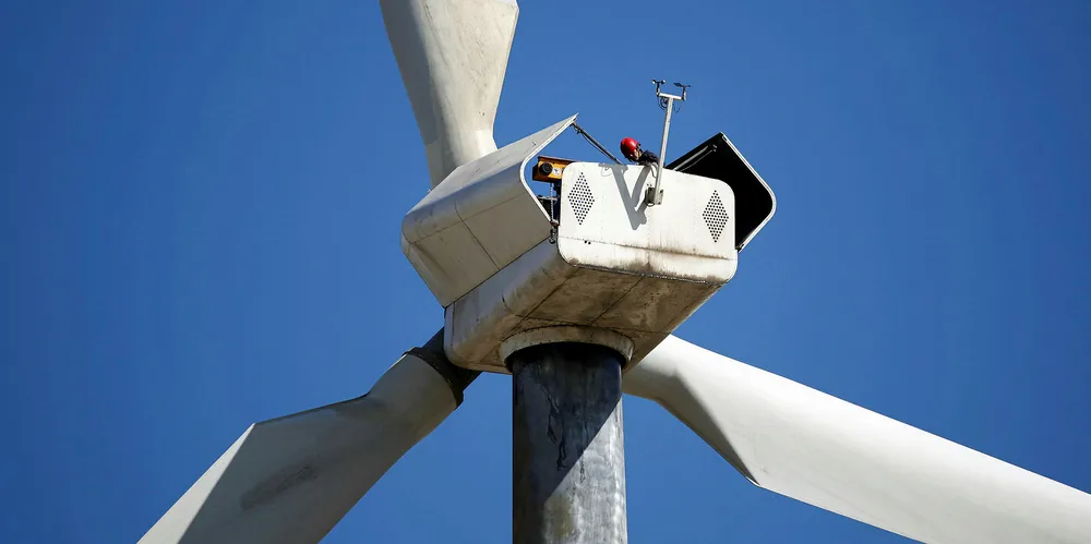 A worker doing maintenance on a wind turbine in Dabancheng Wind Power plant in Dabancheng district of Urumqi, northwest China's Xinjiang Uygur Autonomous Region.