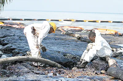 Clean-up: workers tackle an oil spill in Trinidad & Tobago