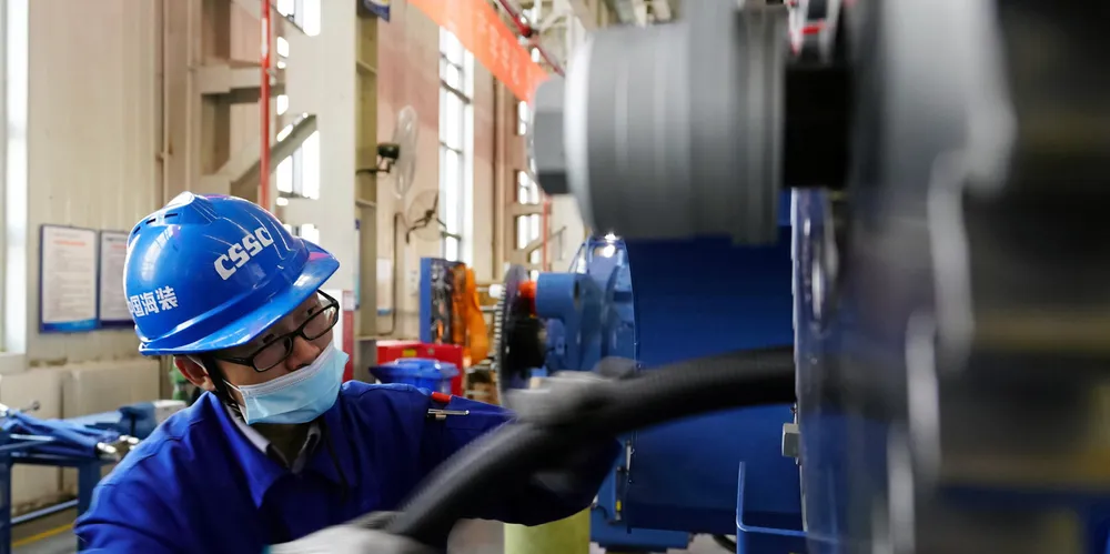 An employee works on the assembly line at a branch of CSSC Haizhuang Windpower Co.