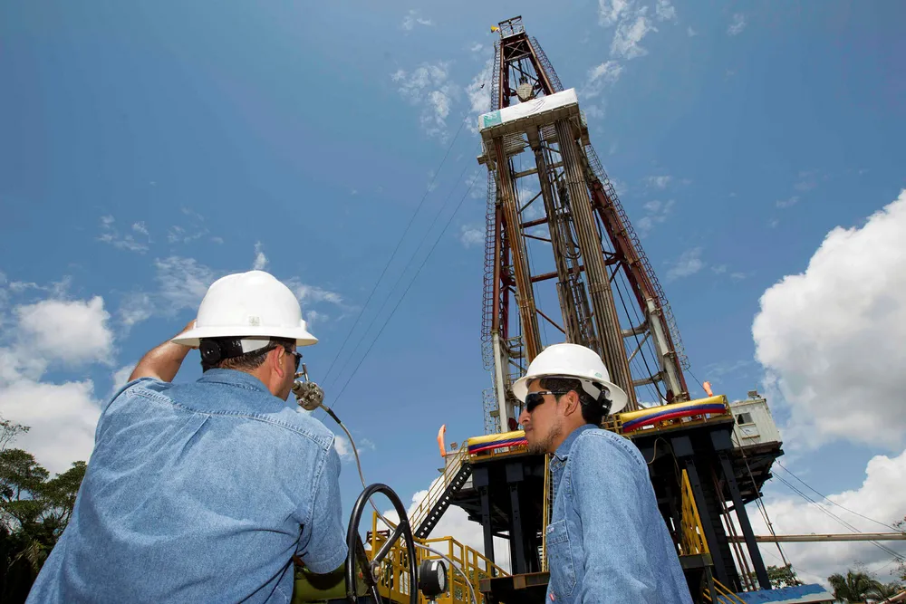Jungle oil: workers stand near a drilling rig on its way to work for Petroamazonas in Ecuador's eastern rainforest region