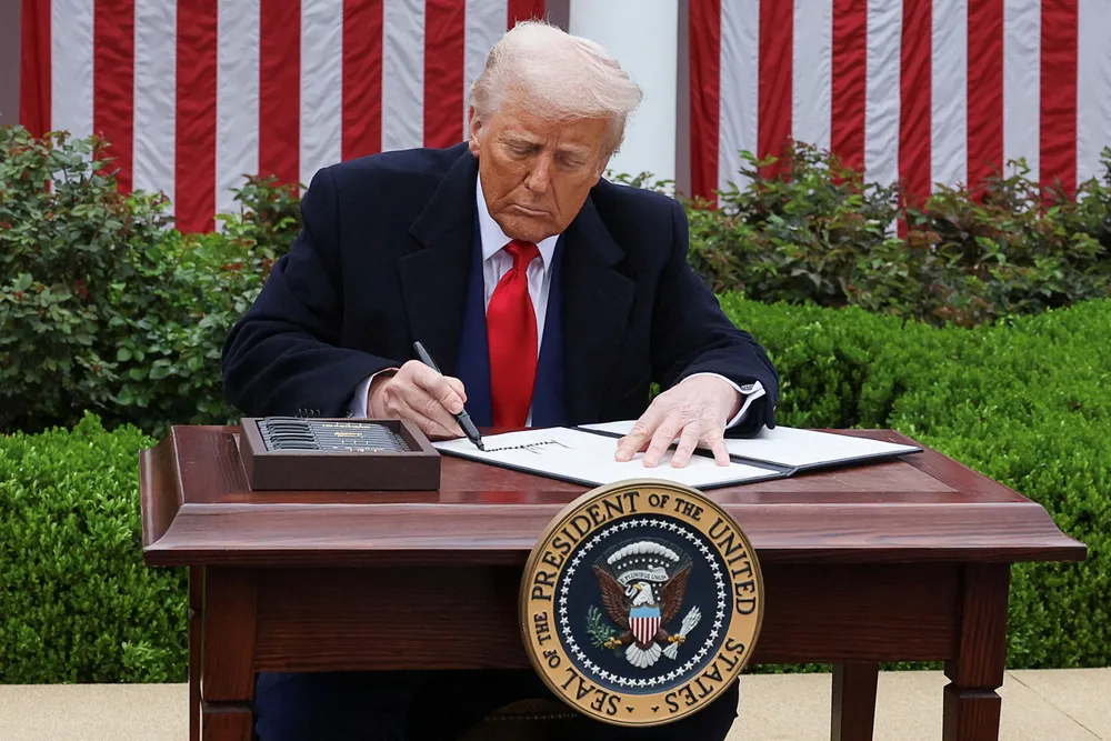 US President Donald Trump signs an executive order on tariffs in the Rose Garden at the White House in Washington, D.C., on Wednesday.