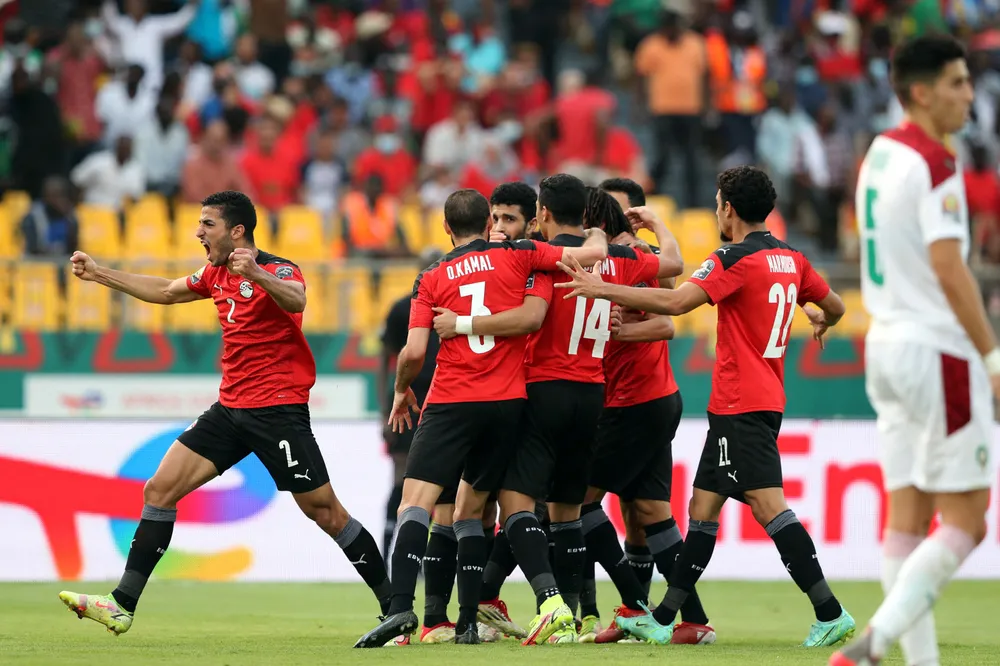 Superstar: Egypt's Mohamed Salah celebrates scoring a goal against Morocco in Yaounde, Cameroon last week, in front of a TotalEnergies advertising hoarding