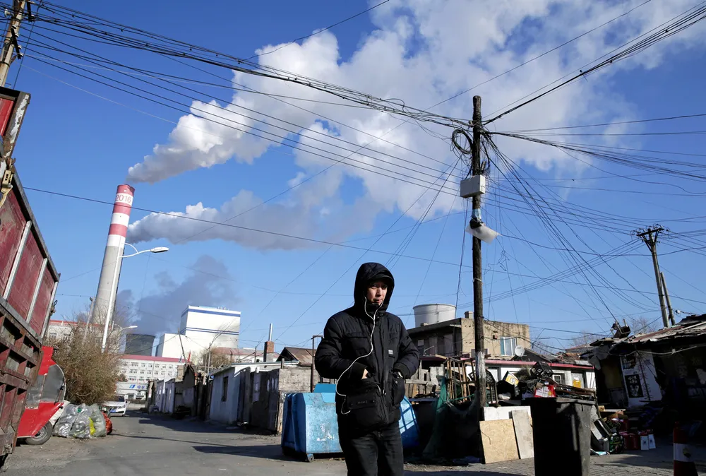 Eye-watering costs: smoke billows from stacks at a coal-fired power station in China