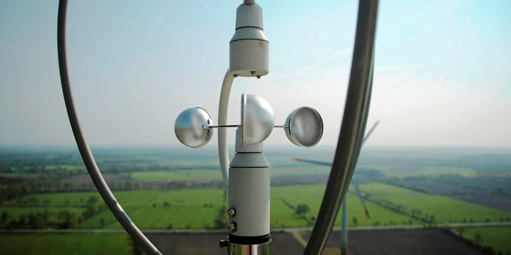 A cup anemometer measuring 'wind speed' on top of a turbine.