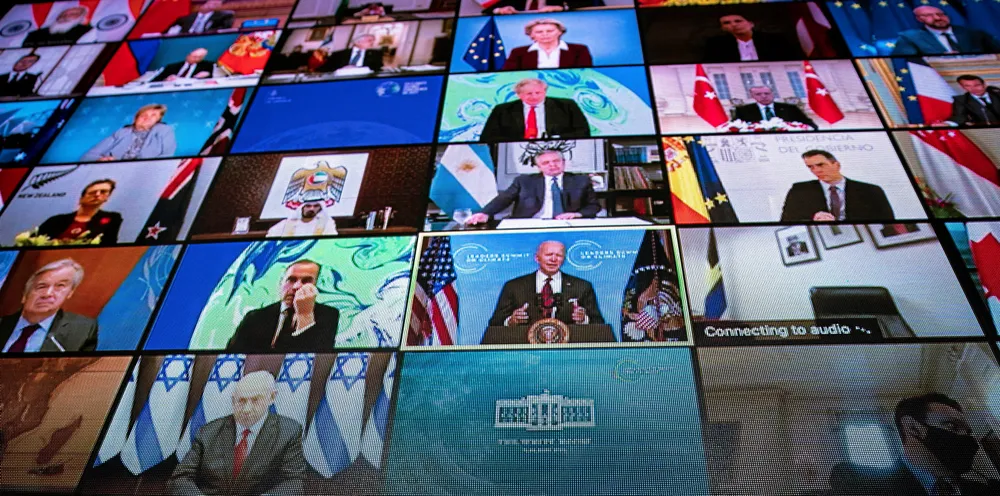 World leaders are seen remotely on a screen as U.S. President Joe Biden delivers remarks during a virtual Leaders Summit on Climate with 40 world leaders in the East Room of the White House April 22, 2021.
