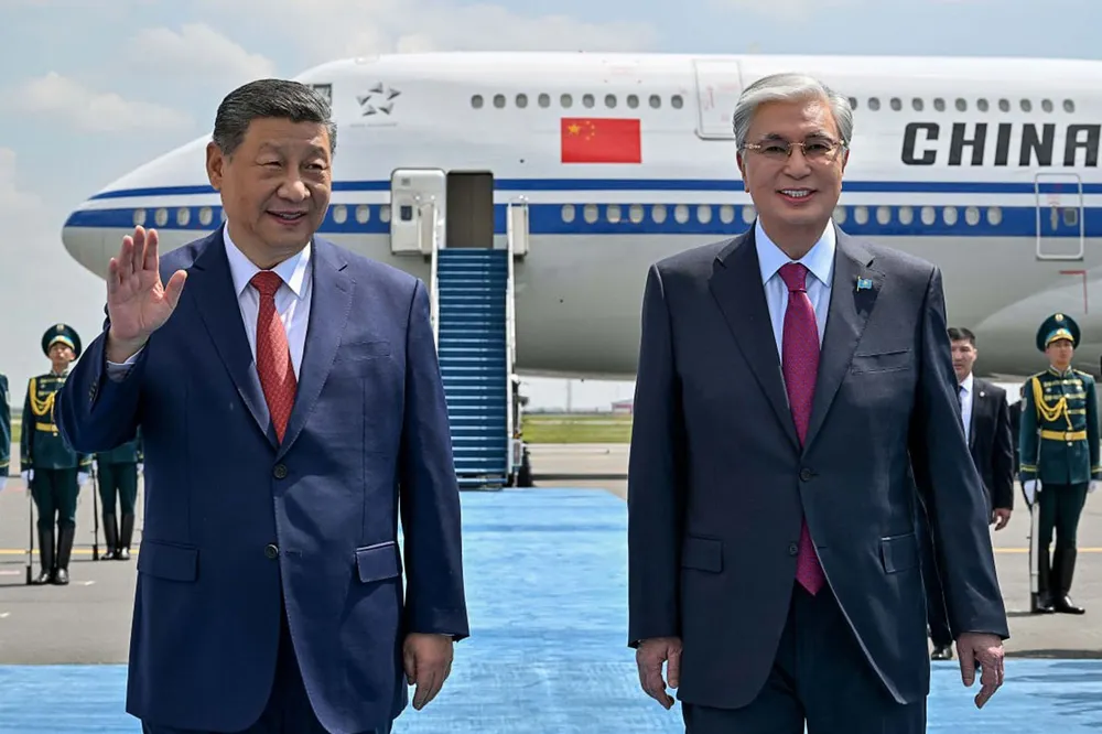 Kazakhstan’s President Kassym-Jomart Tokayev (right) welcomes China's President Xi Jinping upon his arrival to country's capital of Astana.