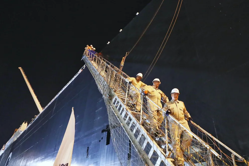 Karim Badawi, Egypt’s Minister of Petroleum (front), on a walkway between the Energos Power FSRU and a jetty in Alexandria port.