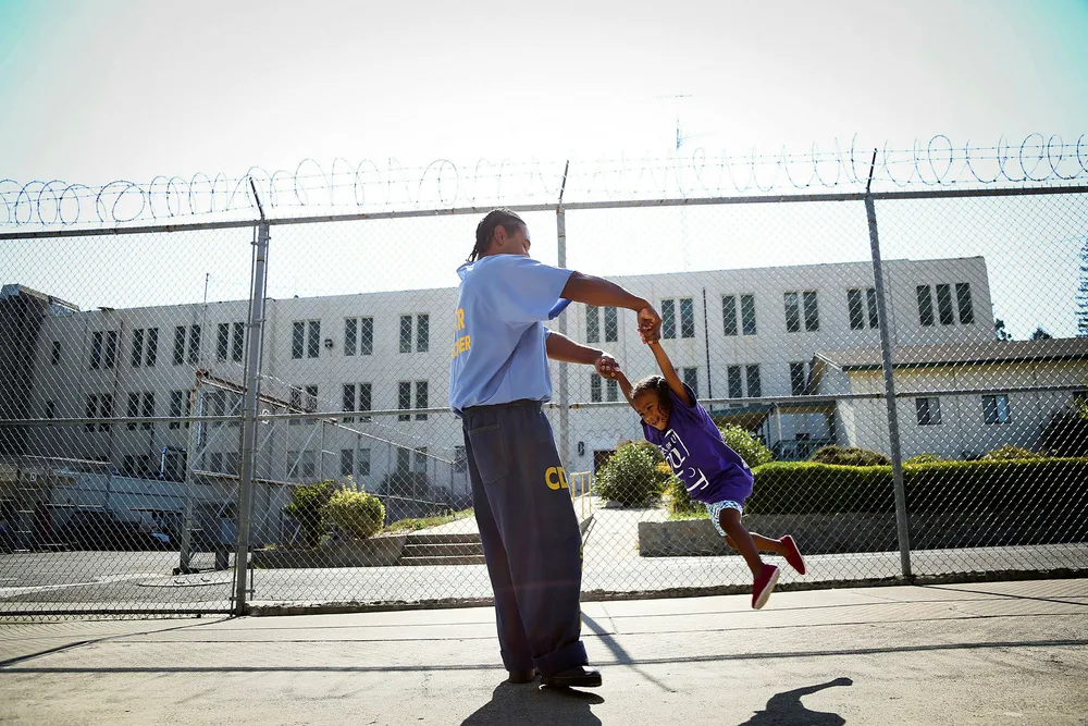 Kriminalreformen i USA gjør det en smule bedre for familier, barn og kvinnelige innsatte. Her leker innsatte Pharaoh Haywood med sin to år gamle datter Isis under en beskøksdag i Folsom State Prison i California. Foto: Elijah Nouvelage/Reuters/NTB Scanpix