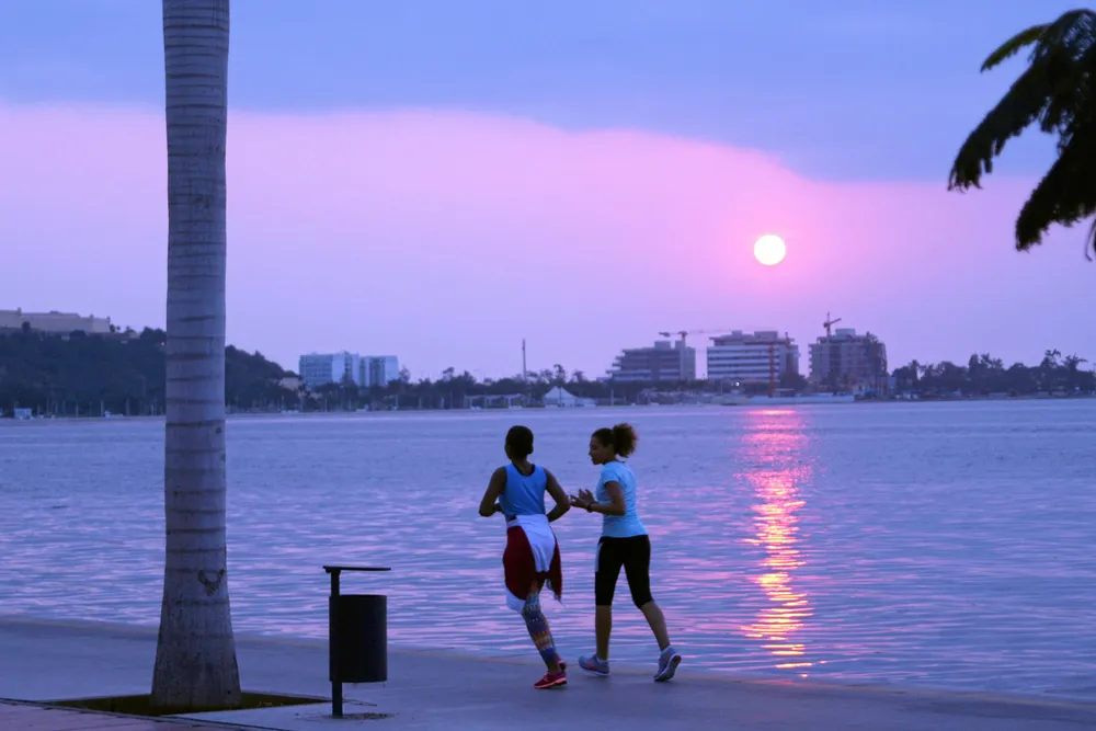 Moving ahead: locals on the beach during sunset in the Angolan capital, Luanda