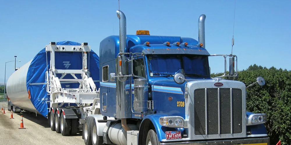 A truck transports a turbine tower.
