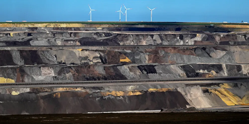 Wind turbines behind the Garzweiler lignite open cast mine operated by German energy giant RWE near Luetzerath, western Germany.