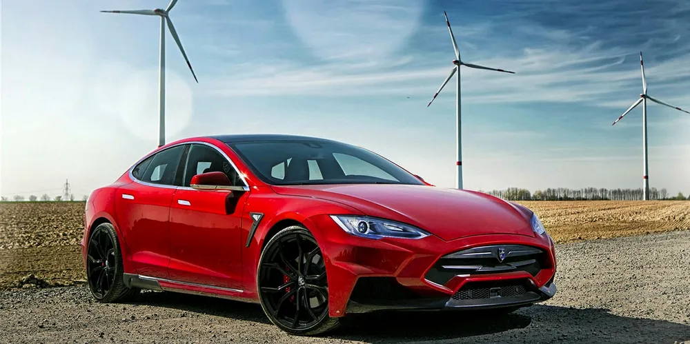 A Tesla electric car at a wind farm
