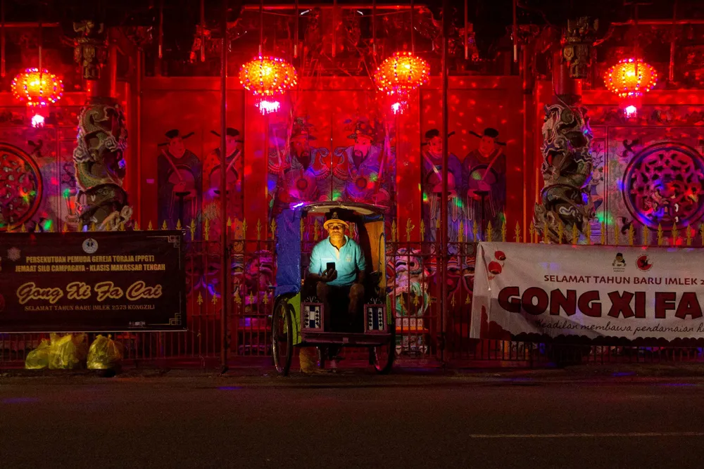 South Sulawesi: a man prays at a temple in the provincial capital Makassar during Lunar New Year