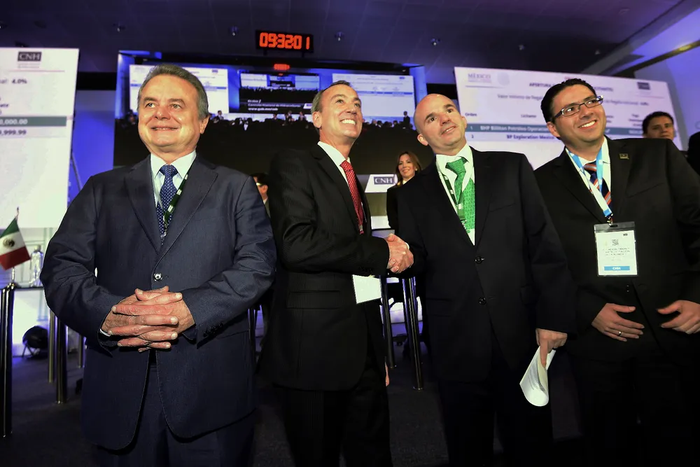 Left to right: Mexican Energy Minister Pedro Joaquin Codwell; Timothy Joseph Callahan, a representative of BHP Billiton Petroleo Operaciones de Mexico; Pemex oil company president Jose Antonio Gonzalez; and the president of the National Hydrocarbons Commission, Juan Carlos Zepeda, pose for photographers at the Centro Banamex, where BHP won the auction for the Trion oilfield with an investment of 624 million dollars, in Mexico City on December 5, 2016. / AFP PHOTO / ALFREDO ESTRELLA