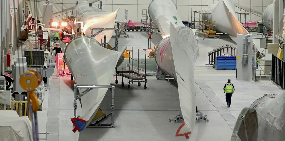 Workers prepare blades for wind turbines at a factory in Aurich, Germany.