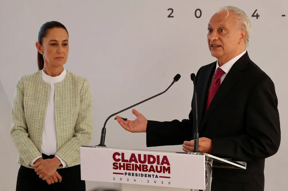 Victor Rodriguez, chief executive of Pemex, speaks next to Mexico's President Claudia Sheinbaum in August 2024