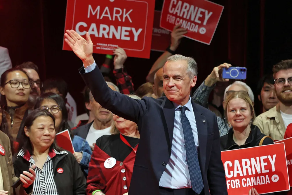 Canada's Prime Minister and Liberal Party leader Mark Carney waves to supporters at a victory party in Ottawa, Ontario