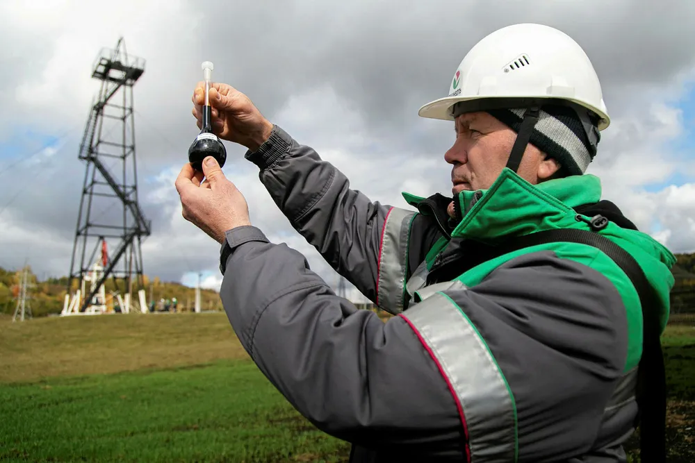 Unwanted oil: a worker takes an oil probe at Bashneft's producing unit Tuymazaneft in Bashkiria in Russia