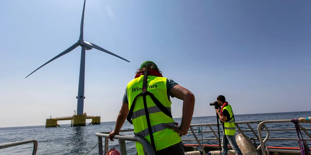Cameramen are seen taking images of WindFloat Atlantic off the coast of Viana do Castelo.