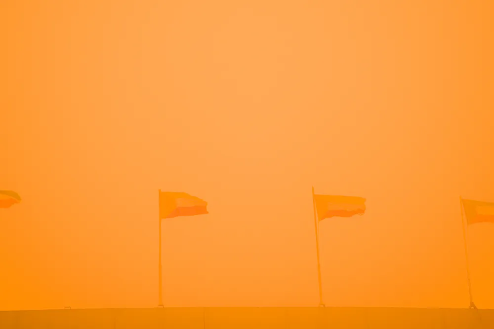 Dust storm: Kuwaiti flags fly on a bridge engulfed by a sandstorm