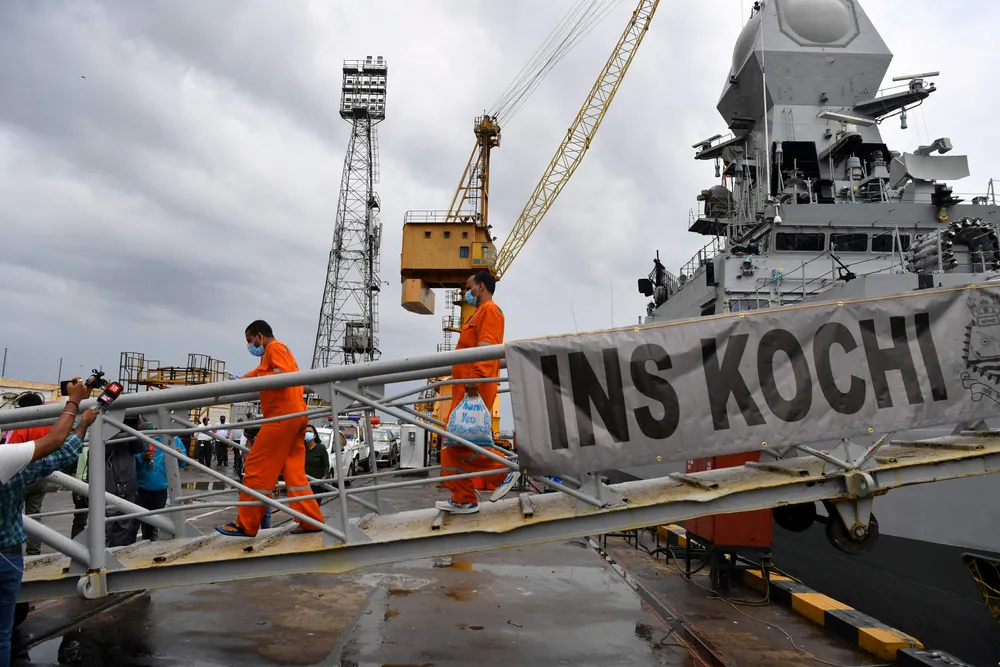 Survivors: rescued workers from Afcons' stricken barge Papaa 305 disembark from the Indian Navy's INS Kochi in Mumbai on 19 May