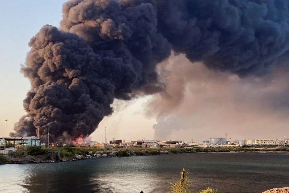 A large plume of smoke rising from a fuel depot in Port Sudan, Sudan.