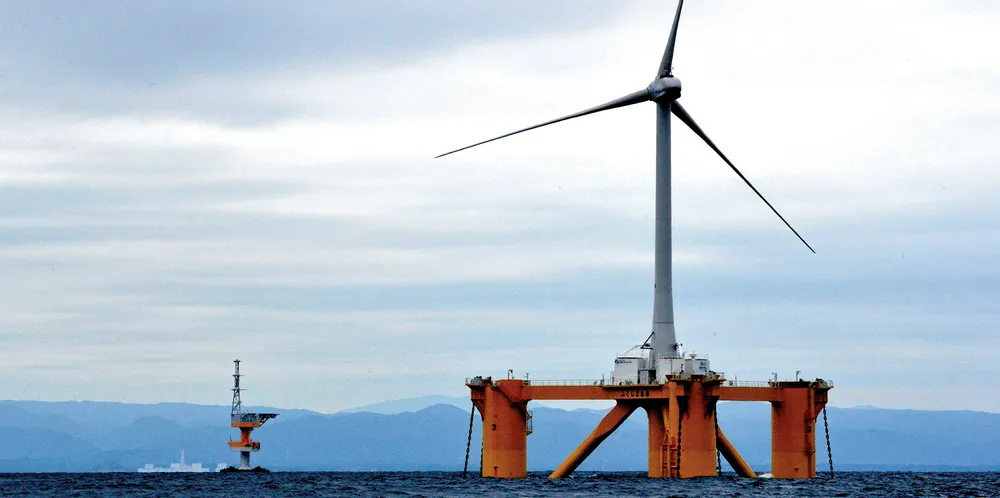 One of the floating wind turbines at Japan's pioneering Fukushima Forward project, with the crippled Tokyo Electric Power Fukushima Dai-ichi nuclear power plant in the distance