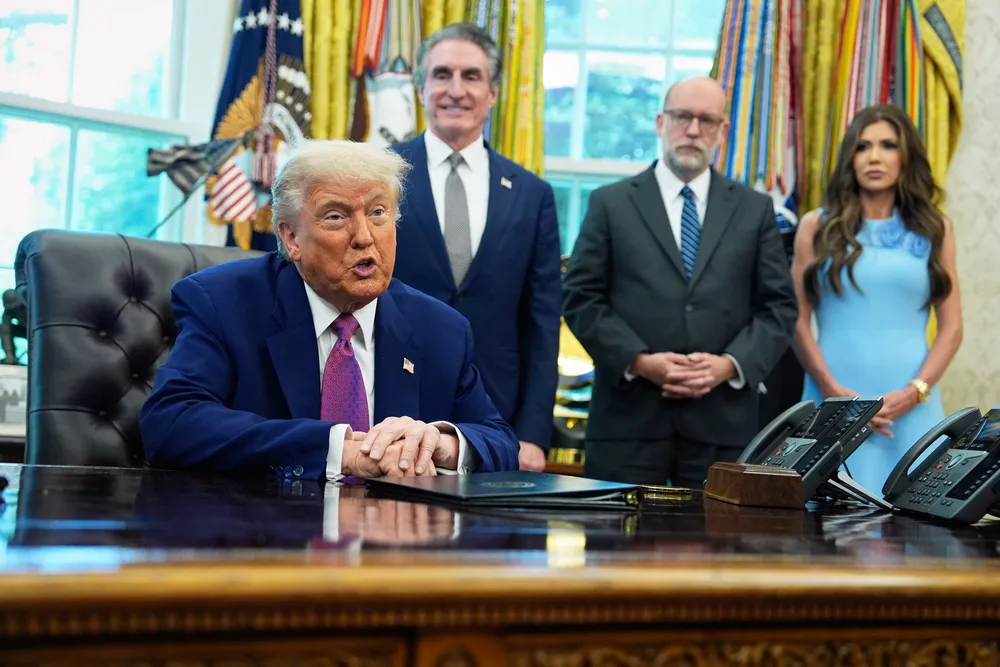 US President Donald Trump speaks to the media in the Oval Office at the White House earlier this month, as Interior Secretary Doug Burgum, Director of the Office of Management and Budget Russell Vought and Secretary of Homeland Security Kristi Noem look on.