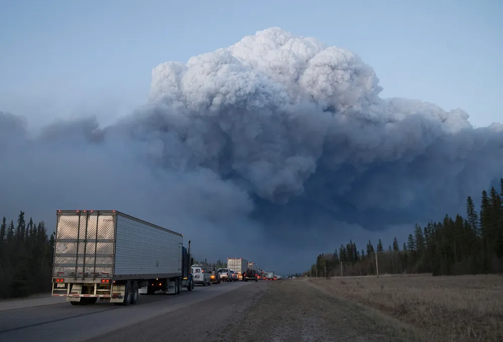 Emergency: Drivers wait to take firefighting supplies into Fort McMurray