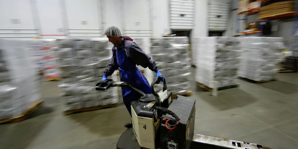 A forklift operator zooms past pallets of Imported frozen seafood from China inside the refrigerated warehouse at Pacific American Fish Company imports (PAFCO) in Vernon, California.