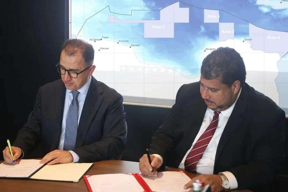 Turkish Petroleum general manager Ahmet Turkoglu (left) and NOC chairman Masoud Suleman sign an exploration deal.