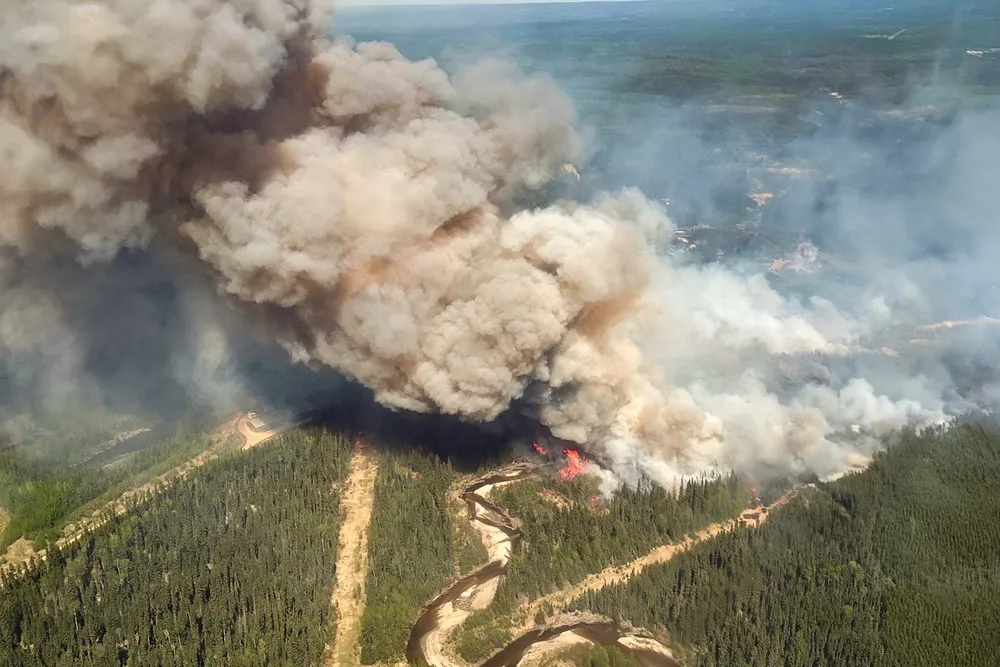 Smoke rises from Edith Lake wildfire SWF076, which forced the evacuation of the nearby town of Swan Hills, Alberta, Canada, shown in an aerial photograph 25 May 2025.