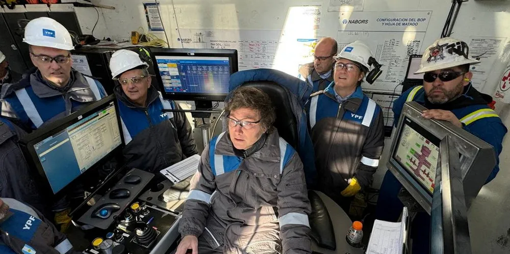 Argentine President Javier Milei (centre) operates equipment of state-owned oil company YPF during a visit to the Vaca Muerta oilfield.
